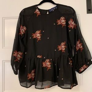 Peplum top with appliqué detailing